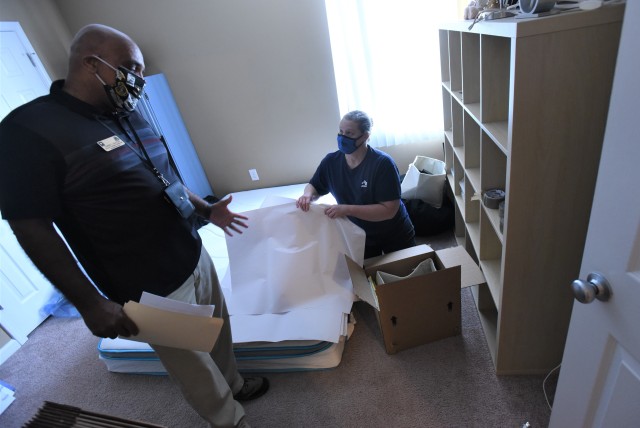 Jay Glover, a transportation quality control inspector, talks to Jennifer Mays, an employee of Shetler-Derby Moving & Storage, about what steps she and others have taken to ensure safety during a recent moving job at Fort Knox, Ky., June 16, 2020.