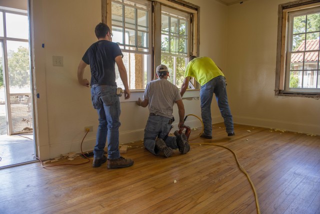 Workers install new windows in a historic home at Fort Benning, Ga., Oct. 1, 2020, as part of a broader effort underway to curb lead-based paint hazards in households.