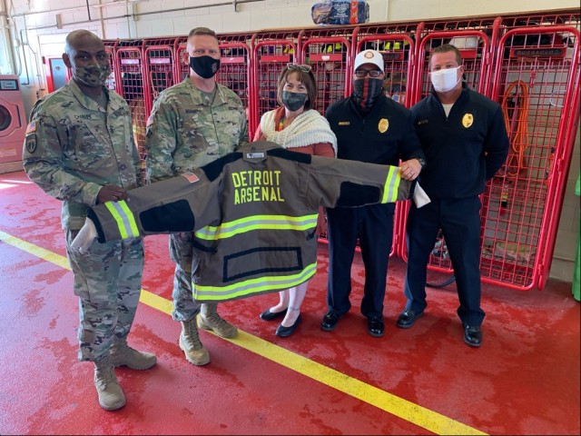 Two members of the Detroit Arsenal Fire Department pose with Command Sgt. Maj. Jerry Charles, Tank-automotive and Armaments Command, Brig. Gen. Darren Werner, commanding general TACOM, and Carrie Mead, Detroit Arsenal Garrison Manager.  The three...