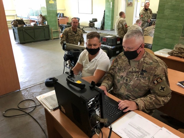 Sgt. Maj. Michael Alvis of Champaign, Illinois, Noncommissioned Officer-in-Charge of Task Force Illini’s Brigade Advisors demonstrates how to prepare a simulator during Javelin anti-tank missile training at the Armed Forces Ukraine’s 209th...