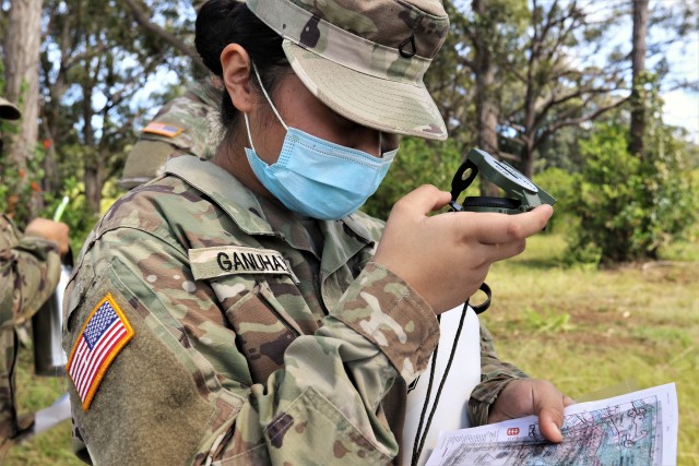 PFC Roshelle Ganuhay, a culinary specialist with Headquarters and Headquarter Company, 311th Signal Command (Theater) shoots an azimuth during a land navigation refresher-training course at the Army’s East Range on Oahu, Oct. 3-4, 2020.  More than 60 Active and Reserve component Soldiers assigned to HHC, 311th SC (T), conducted the daylong event, which began at 8 a.m. The course was part of an annual training requirement for active duty soldiers and a bi-annual training requirement for Army Reserve Soldiers. The training requirement was mandatory for enlisted ranks of grades E-7 and below and officers of grades O-2 and below. (Official U.S. Army photo by Marc Ayalin)
