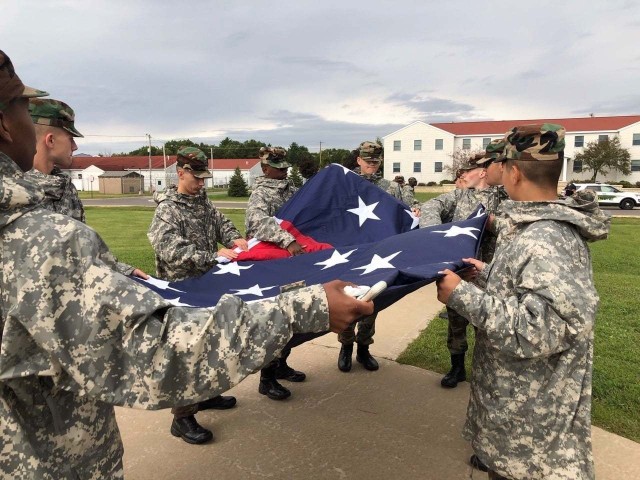 Wisconsin Challenge Academy cadets participate in a flag-raising effort Sept. 7, 2020, at the garrison flagpole at Fort McCoy, Wis. The Challenge Academy, a Fort McCoy tenant organization, offers youth the opportunity to change the direction of their lives and develop the strength of character and life skills necessary to become successful, responsible citizens. The program begins with a 5 1/2-month residential phase, followed by a one-year, post-residential phase. (Photo courtesy of the Wisconsin Challenge Academy staff.)