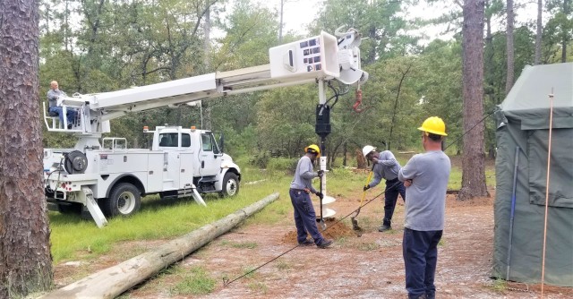 Members of the Directorate of Public Works install poles for lightning protection systems at a training site on Fort Jackson, Sept. 25. During the last fiscal
...