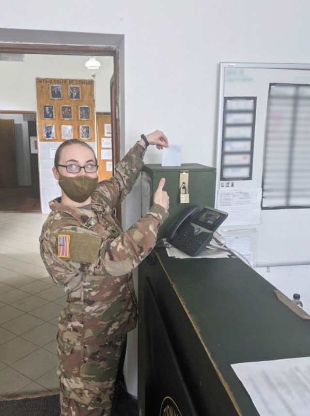 Task Force Illini Soldier Sgt. Kristina Brown submits her absentee voter ballot to the mail drop-off box at the U.S. Army Joint Multinational Training Group-Ukraine Headquarters, Oct. 6. (Photo by U.S. Army Sgt. Gregory Glosser, JMTG-U Public Affairs)