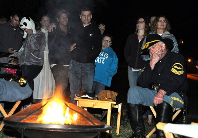 Friends of the Frontier Army Museum Haunted Tour participants gather around a campfire to hear retired Col. Sam Young, dressed in a reproduction 1872 Cavalry chief trumpeter's uniform, tell about the odd things that have been experienced on Main...