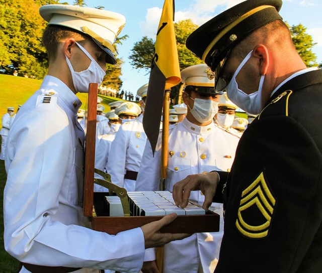 A brigade tactical noncommissioned officer starts to distribute the rings to the Class of 2021 at the Ring Ceremony.