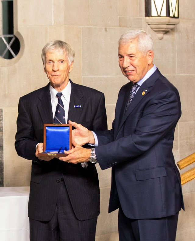 U.S. Ambassador Ryan C. Crocker (center) receives the Thayer Award Medal from the Chairman of the Board of Directors of the West Point Association of Graduates, Joseph E. DeFrancisco.