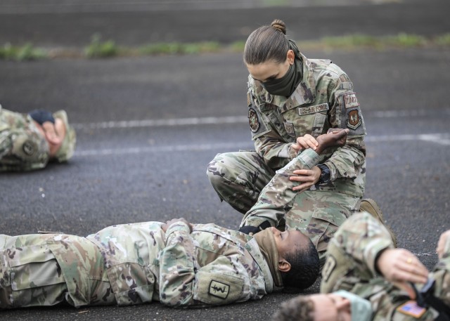 U.S. Air Force Tech Sgt. Emily Mercante, an independent Duty Medical Technician at Landstuhl Regional Medical Center checks the pulse of U.S. Army Sgt. Maj. Chris Johnson, clinical operations sergeant major, 30th Medical Brigade, during tourniquet drills as part of the International Trauma Combat Casualty Care course at LRMC, Sept. 30. The international course, which included Service Members from four Nations, was aimed at providing unit-level health care providers life-saving instruction to increase survivability at the point of injury.