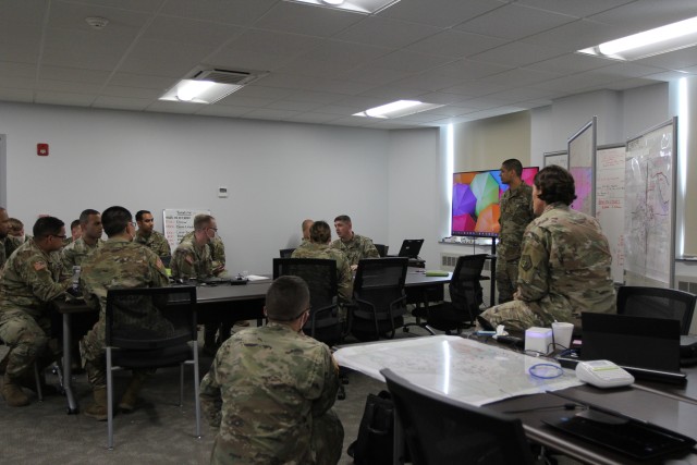 BUTLERVILLE, Ind. – Lt. Col. Matthew Davis, commander of the 915th Cyber Warfare Battalion, and Command Sgt, Maj. Marlene Harshman, the battalion’s senior enlisted leader, conduct an after action review (AAR) during the battalion’s Field Training Exercise at Muscatatuck Urban Training Center, October 8.