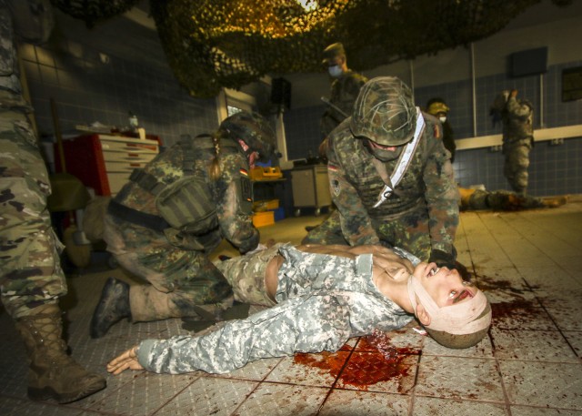 Service Members assess a simulated casualty during the Care Under Fire (CUF) portion of the International Trauma Combat Casualty Care course at Landstuhl Regional Medical Center, Sept. 30. The international course, which included Service Members...