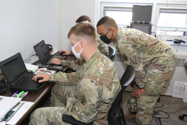 BUTLERVILLE, Ind. – Staff Sgt. Austin Moss, a fire support specialist (foreground), and Sgt. 1st Class Brian Samuels, Expeditionary CEMA (cyberspace electromagnetic activities) Team, ECT-01 plans section NCOs, are participating in the battalion’s Field Training Exercise at Muscatatuck Urban Training Center, Oct. 7.