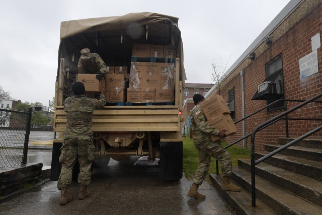 Soldiers with the Maryland Army National Guard deliver boxes of food to the Crispus Attucks Recreation Center in Baltimore, Md., April 24, 2020. Soldiers assisted state and local officials with distributing food to schools and recreation centers throughout Baltimore as part of the COVID-19 response.