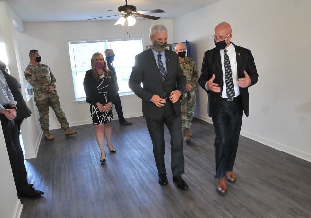Patrick L. MacKenzie, deputy to the garrison commander, right, explains the Jackson Circle housing renovation project to The Honorable James McPherson, Under Secretary of the Army, during a visit to the neighborhood Oct. 7.