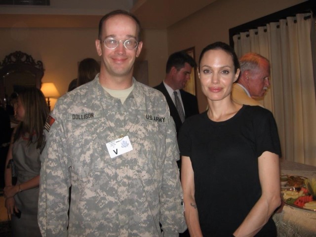 Due to his work in support of refugees, Dollison meets Angelina Jolie while stationed in Baghdad.