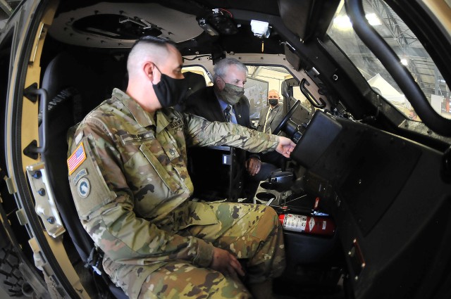 Staff Sgt. Derrick Felch, Ordnance School instructor, explains Joint Light Tactical Vehicle controls to The Honorable Under Secretary of the Army James McPherson during the secretary’s Oct. 7 visit.
