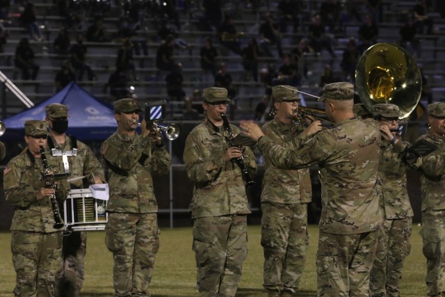 The 3rd Infantry Division band, led by Chief Warrant Officer 3 Mike Krzmarzick, perform a half-time show during a military appreciation game between Bradwell Institute and Richmond Hill High School Oct. 9, 2020, at Olvey Field, Hinesville,...