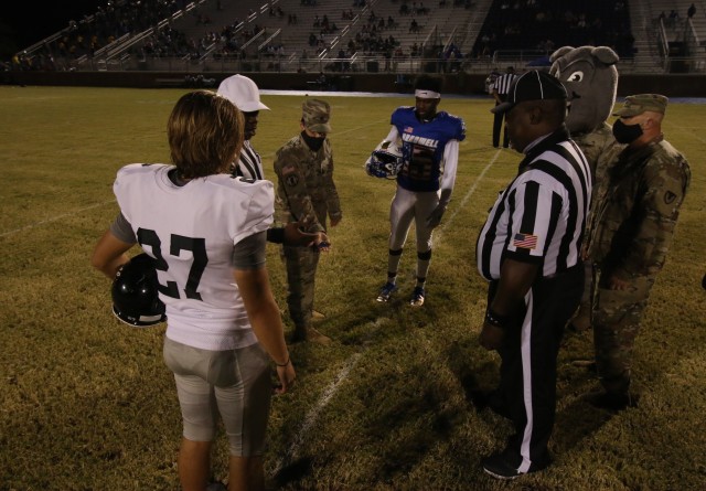 Command Sgt. Maj. Rebecca Myers, Fort Stewart and Hunter Army Airfield senior enlisted advisor, prepares to toss the ceremonial coin before a military appreciation game between Bradwell Institute and Richmond Hill High School Oct. 9, 2020, at...