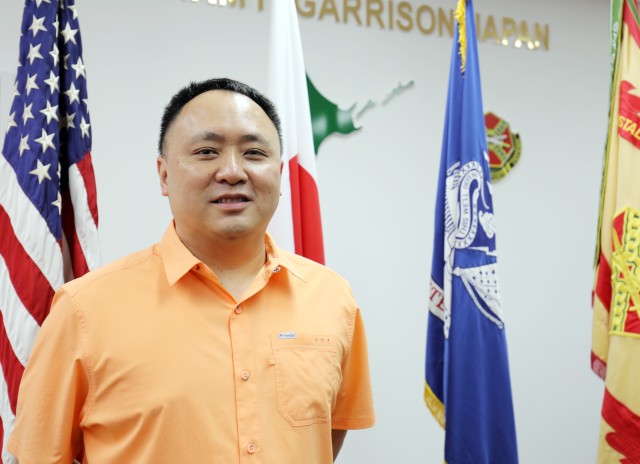 Kai Yuan, retirement services officer for U.S. Army Garrison Japan, poses for a photo in Building 102, Camp Zama, Japan, Oct. 14.