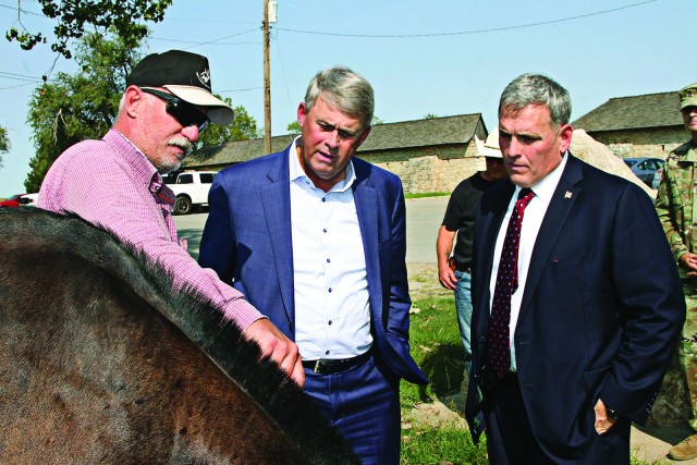 Gerald Stuck, Artillery Half Section chief; explains General Halverson’s brand to retired Lt. Gen. David Halverson; and Glenn Waters, Directorate of Plans, Training, Mobilization, and Security director, Sept. 30, 2020, at the stables. General...