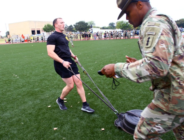 Senior Drill Sergeant (Sgt. 1st Class) Jessie Everette, C Battery, 95th Adjutant Battalion (Reception), performs the sprint-drag-carry event as an evaluator monitors his progress during the Iron Destroyer Games.