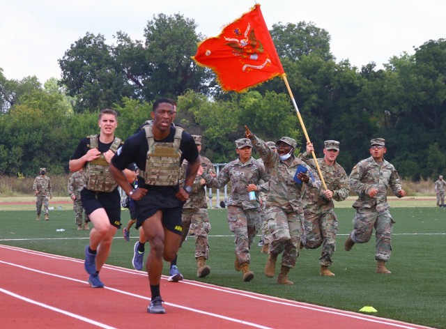 Soldiers with 1st Battalion, 40th Field Artillery at Fort Sill, Oklahoma, run inside the track at Hellcat Field as they cheer on their team during the Iron Destroyer Games Oct. 9, 2020. Dozens of Soldiers and family members came out to encourage the competitors.