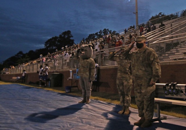 3rd Infantry Division mascot Rocky the Bulldog, Command Sgt. Maj. Rebecca Myers, Fort Stewart and Hunter Army Airfield senior enlisted advisor, and Col. Bryan Logan, Fort Stewart and Hunter Army Airfield garrison commander, salute during the...