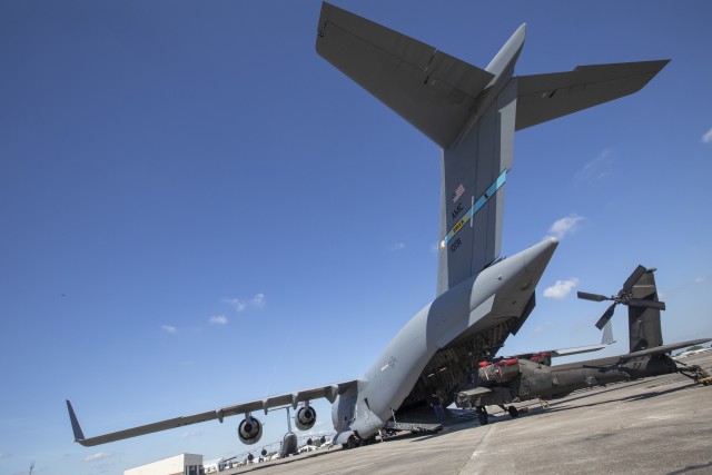 U.S. Army Soldiers from the 3rd Combat Aviation Brigade, 3rd Infantry Division, prepare to load an AH-64 Apache helicopter onto a C-17 Globemaster aircraft during joint air load training at Hunter Army AIrfield, Georgia, Oct. 7. This training is vital to ensuring the joint forces are ready to safely and efficiently load equipment onto Air Mobility Command aircraft, ensuring rapid global mobility and combat power projection. (U.S. Army photo by Sgt. Andrew McNeil 3rd Combat Aviation Brigade, 3rd Infantry Division)