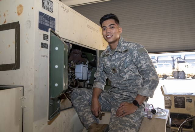 U.S. Army Spc. Seigfred R. Velarde, a tactical power generation specialist with Bravo Company, 710th Brigade Support Battalion, 3rd Brigade Combat Team 10th Mountain Division, sits on the wheel well of a 30,000-watt diesel engine generator set, inside the work bay of the brigade supply activity motor pool, Fort Polk, Louisiana, October 13, 2020. Velarde worked around the clock to troubleshoot and repair three mission-essential generators after Hurricane Laura knocked out power across southern and central Louisiana, August 27, 2020. (U.S. Army photo by Staff Sgt. Ashley M. Morris)