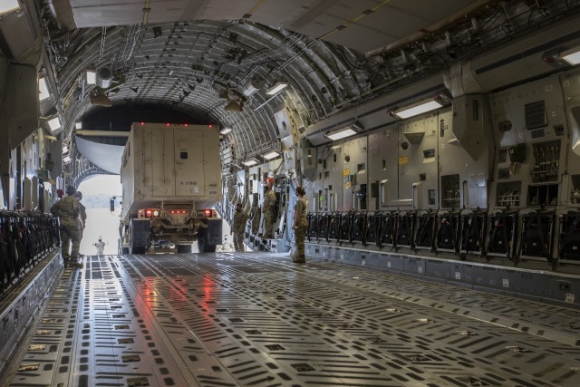 U.S. Army Soldiers from the 3rd Combat Aviation Brigade, 3rd Infantry Division, and the Airmen from the 3rd and 9th Airlift Squadrons, 621st Mobility Support Operations Squadron, load a medium tactical vehicle onto a C-17 Globemaster aircraft while conduct joint air load training, Oct. 6, Hunter Army Airfield, Georgia. This training is vital to ensuring the joint forces are ready to safely and efficiently load equipment onto Air Mobility Command aircraft, ensuring rapid global mobility and combat power projection. (U.S. Army photo by Sgt. Andrew McNeil 3rd Combat Aviation Brigade, 3rd Infantry Division)