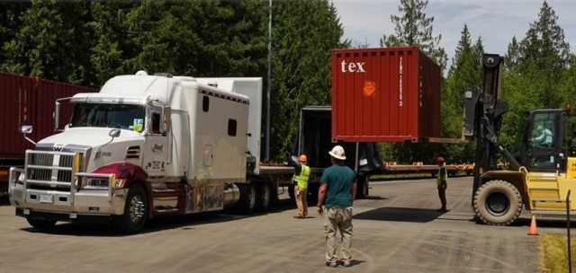 Transitioning containers from the rail to trucks at Kitsap Bangor rail transition yard.