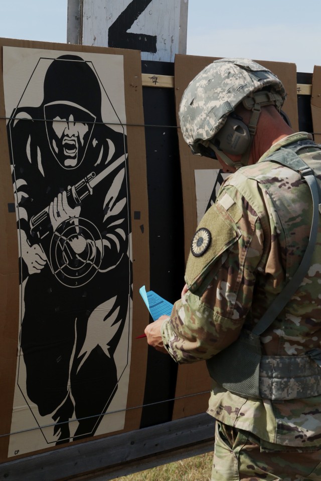 Soldiers inspect their targets after firing off their rounds to evaluate their own shooting skills during the Adjutant General’s Combat Marksmanship Championship Match at the Kansas Regional Training Center in Salina, Kansas, Sept. 27, 2020. Checking his progress allows him to make any adjustments needed to better himself and his scores.
