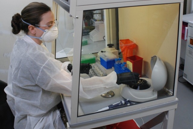 Spc. Taylor Wolik, a medical laboratory specialist with the 1st Area Medical Laboratory, performs a diagnostic assay at the U.S. Army Medical Research Institute of Infectious Diseases field laboratory site at Fort Detrick, Md. Army leaders...