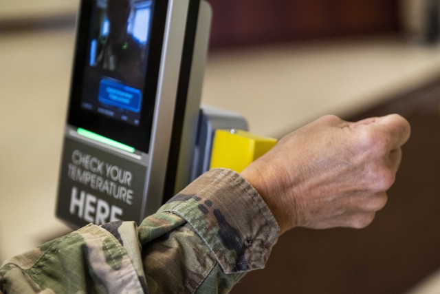 A U.S. Army Soldier scans her wrist temperature and her face at a terminal newly installed to screen for high temperatures of people entering Marshall Hall, the U.S. Army Reserve Command and U.S. Forces Command headquarters building at Fort Bragg, N.C., Sept. 29, 2020. The terminal is expected to reduce and eventually eliminate the required staffing of Soldiers who currently screen people&#39;s temperatures coming into the building. The terminal scans body temperatures via the wrist to eliminate contact and stores up to 10,000 face images, which can help with contact tracing if someone is later found to test positive for COVID-19. 