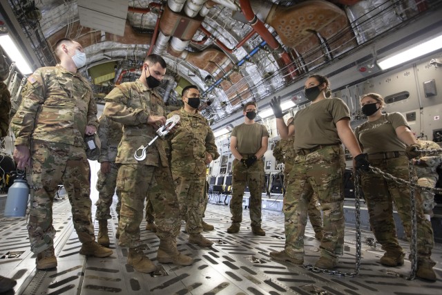 U.S. Army Soldiers from the 3rd Combat Aviation Brigade and 3rd Sustainment Brigade, 3rd Infantry Division, learn to properly strap down equipment while conducting joint air load training with the Airmen from the 3rd and 9th Airlift Squadrons, 621st Mobility Support Operations Squadron, Oct. 6, Hunter Army Airfield, Georgia. This training is vital to ensuring the joint forces are ready to safely and efficiently load equipment onto Air Mobility Command aircraft, ensuring rapid global mobility and combat power projection. (U.S. Army photo by Sgt. Andrew McNeil 3rd Combat Aviation Brigade, 3rd Infantry Division)