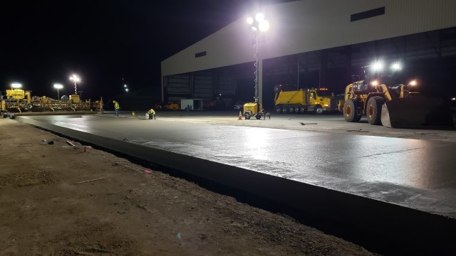 Contractors check the edging of a concrete test lane poured Sept. 1 for the Joint Base Pearl-Harbor Hickam F-22 Fighter Alert Facility project.  Construction of the $43 million project is one example of how USACE helps sustain our Armed Forces...