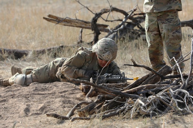 A Soldier with 4th Infantry Division adjusts his weapon while reacting to simulated indirect fire at the weapons lane during Expert Infantryman Badge and Soldier Expert Badge testing Oct. 14 at Fort Carson, Colo. The EIB and ESB is awarded to infantrymen and Soldiers, respectively, for demonstrating their competence and readiness as infantrymen and Soldiers. (U.S. Army photo by Sgt. Gabrielle Pena)