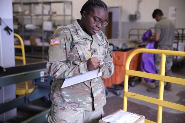 U.S. Army Spc. Jazmine Reed, assigned to 5th Battalion, 101st Combat Aviation Brigade, 101st Airborne Division (Air Assault), inventories parcels coming off of a mail truck at the Storck Barracks Army Post Office in Illeshiem, Germany, October 9,...