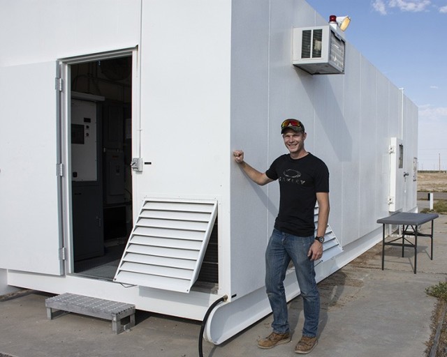 Test Officer A. J. Line, in front of the fungus chamber at Dugway Proving Ground. Many tested items spend a month or more in the warm, humid, dark chamber, where the growth of fungus is encouraged. The fungus test is part of the Military Standard 810 requirement that designates how an item will be tested to ensure it can endure a variety of conditions.
