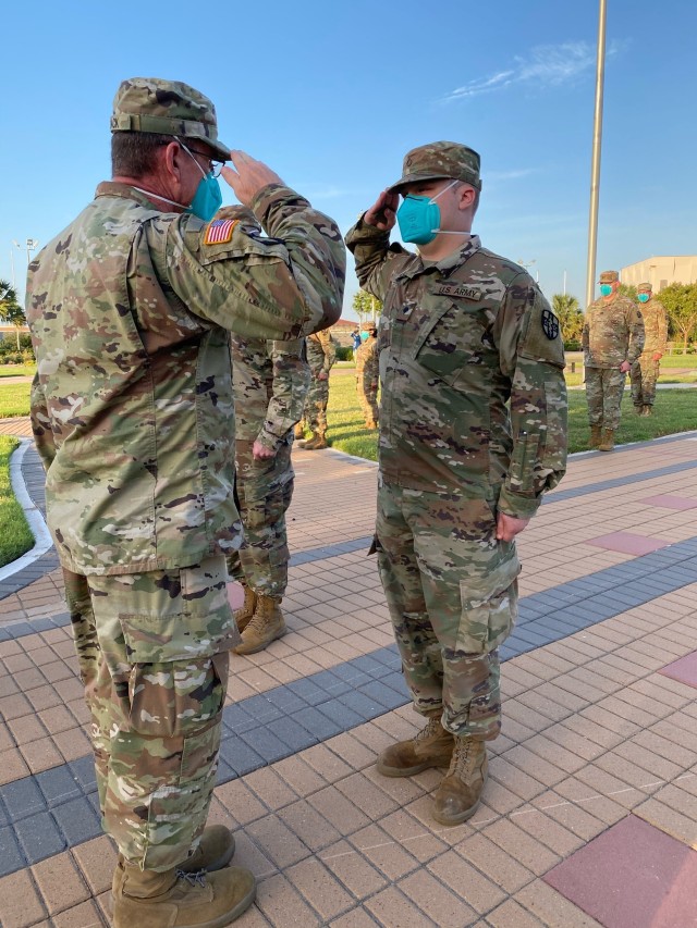 Army Reserve combat medic Duncan Crow (right) is advanced to the rank of specialist by Col. Robert Black, commander of UAMTF-7452, during a ceremony held at the Veterans Memorial Park in McAllen, Texas, Sept. 8, 2020. Crow, from Semmes, Alabama, was mobilized with the UAMTF to support DHR Health in Edinburg, Texas as part of the Department of Defense assistance to the Federal Emergency Management Agency response to the COVID-19 pandemic.