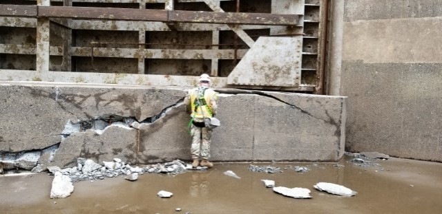 An engineer inspects damage to the sill block in the Bonneville navigation lock chamber. The damage to the navigation lock sill stopped water-borne commerce on the Columbia River for three weeks as crews worked to repair the damage.