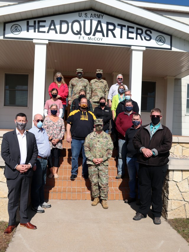 Local community leaders are shown with the Fort McCoy Garrison command team Oct. 6, 2020, during a special visit by the leaders to Fort McCoy, Wis. More than a dozen civic leaders from Tomah and Sparta, Wis., participated in the community leader engagement. The event included involvement from the Fort McCoy Garrison command team, including Garrison Commander Col. Michael D. Poss; Garrison Deputy Commander Lt. Col. Alexander L. Carter; Command Sgt. Maj. Paul Mantha, garrison command sergeant major; Deputy to the Garrison Commander Brad Stewart; Directorate of Public Works Director Liane Haun; Directorate Plans, Training, Mobilization and Security Director Mike Todd; Directorate of Emergency Services Director Mark Fritsche; and many more. The 13 civic leaders included acting Tomah Veterans Administration Medical Center Director Karen Long; Tomah Mayor Mike Murray; Tomah Chamber of Commerce President and Chief Executive Officer Tina Thompson; Tomah business leaders Philip Stuart, Jeffery Cram, and Christian Dawley; Tomah Police Chief Mark Nicholson; Tomah School Superintendent Dr. Mike Hanson; Sparta Chamber of Commerce Executive Director Heidi Prestwood; Sparta Chamber business leaders Suzanne Hoffman, Shannon Davis, and Vincent Norris, and Sparta School Superintendent Amy Van Deuren. The visitors received a driving tour around the installation as well as a visit to the Mission Training Complex for simulation training in the 200 block at Fort McCoy. (U.S. Army Photo by Scott T. Sturkol, Public Affairs Office, Fort McCoy, Wis.)