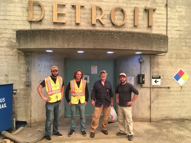 Mike Pomeroy (holding bag) stands with the team that made it to his location after Pomeroy was trapped by wildires at Detroit Dam for nearly 30 hours.