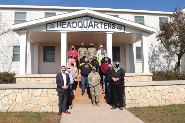 Local community leaders are shown with the Fort McCoy Garrison command team Oct. 6, 2020, during a special visit by the leaders to Fort McCoy, Wis. More than a dozen civic leaders from Tomah and Sparta, Wis., participated in the community leader engagement. The event included involvement from the Fort McCoy Garrison command team, including Garrison Commander Col. Michael D. Poss; Garrison Deputy Commander Lt. Col. Alexander L. Carter; Command Sgt. Maj. Paul Mantha, garrison command sergeant major; Deputy to the Garrison Commander Brad Stewart; Directorate of Public Works Director Liane Haun; Directorate Plans, Training, Mobilization and Security Director Mike Todd; Directorate of Emergency Services Director Mark Fritsche; and many more. The 13 civic leaders included acting Tomah Veterans Administration Medical Center Director Karen Long; Tomah Mayor Mike Murray; Tomah Chamber of Commerce President and Chief Executive Officer Tina Thompson; Tomah business leaders Philip Stuart, Jeffery Cram, and Christian Dawley; Tomah Police Chief Mark Nicholson; Tomah School Superintendent Dr. Mike Hanson; Sparta Chamber of Commerce Executive Director Heidi Prestwood; Sparta Chamber business leaders Suzanne Hoffman, Shannon Davis, and Vincent Norris, and Sparta School Superintendent Amy Van Deuren. The visitors received a driving tour around the installation as well as a visit to the Mission Training Complex for simulation training in the 200 block at Fort McCoy. (U.S. Army Photo by Scott T. Sturkol, Public Affairs Office, Fort McCoy, Wis.)