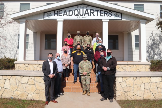 Local community leaders are shown with the Fort McCoy Garrison command team Oct. 6, 2020, during a special visit by the leaders to Fort McCoy, Wis. More than a dozen civic leaders from Tomah and Sparta, Wis., participated in the community leader engagement. The event included involvement from the Fort McCoy Garrison command team, including Garrison Commander Col. Michael D. Poss; Garrison Deputy Commander Lt. Col. Alexander L. Carter; Command Sgt. Maj. Paul Mantha, garrison command sergeant major; Deputy to the Garrison Commander Brad Stewart; Directorate of Public Works Director Liane Haun; Directorate Plans, Training, Mobilization and Security Director Mike Todd; Directorate of Emergency Services Director Mark Fritsche; and many more. The 13 civic leaders included acting Tomah Veterans Administration Medical Center Director Karen Long; Tomah Mayor Mike Murray; Tomah Chamber of Commerce President and Chief Executive Officer Tina Thompson; Tomah business leaders Philip Stuart, Jeffery Cram, and Christian Dawley; Tomah Police Chief Mark Nicholson; Tomah School Superintendent Dr. Mike Hanson; Sparta Chamber of Commerce Executive Director Heidi Prestwood; Sparta Chamber business leaders Suzanne Hoffman, Shannon Davis, and Vincent Norris, and Sparta School Superintendent Amy Van Deuren. The visitors received a driving tour around the installation as well as a visit to the Mission Training Complex for simulation training in the 200 block at Fort McCoy. (U.S. Army Photo by Scott T. Sturkol, Public Affairs Office, Fort McCoy, Wis.)