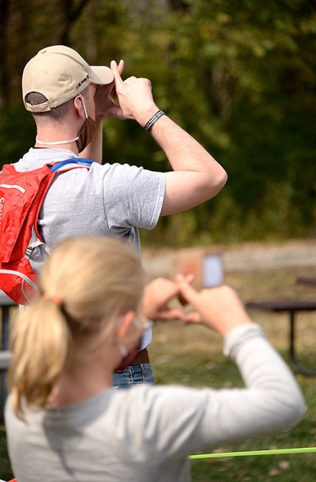 Seven-year-old Elizabeth Prokoph mimics rangemaster and den leader Lt. Col. Neil Wahab, Army University, to find her dominate shooting eye at the BB gun station during the Cub Scout Pack 1 Shooting Sports Day Oct. 17 at Hunt Lodge. Photo by...