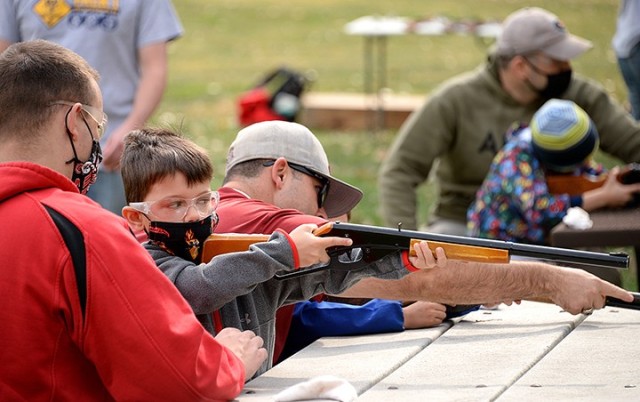 Sgt. 1st Class Tony Sheets helps his 7-year-old son Carter become familiar with using the sight on a BB gun during the Cub Scout Pack 1 Shooting Sports Day Oct. 17 at Hunt Lodge. Photo by Prudence Siebert/Fort Leavenworth Lamp