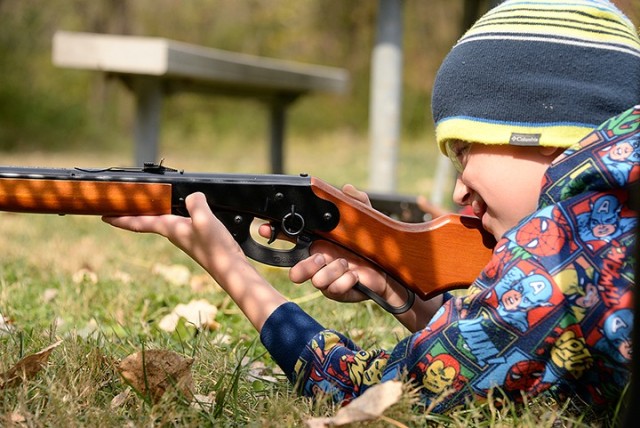 Seven-year-old Micheal Merriss takes aim from a prone position at the BB gun station during the Cub Scout Pack 1 Shooting Sports Day Oct. 17 at Hunt Lodge. Photo by Prudence Siebert/Fort Leavenworth Lamp