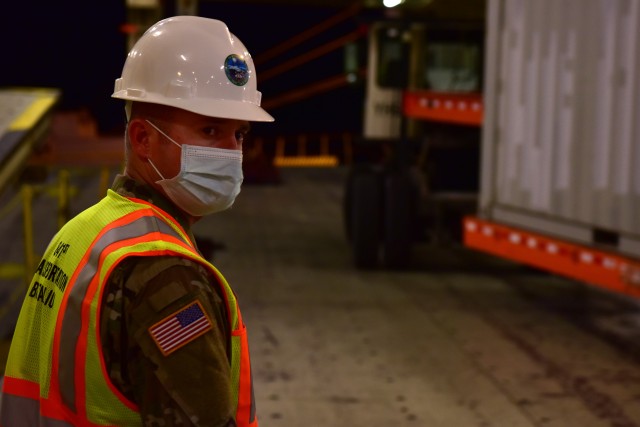 U.S. Army Sgt. 1st Class Blake Interdonato, an Operations NCOIC mobilized with the 841st Transportation Battalion, monitors equipment being offloaded the cargo vessel at Joint Base Charleston’s Naval Weapons Station, S.C., Oct. 14, 2020. The...