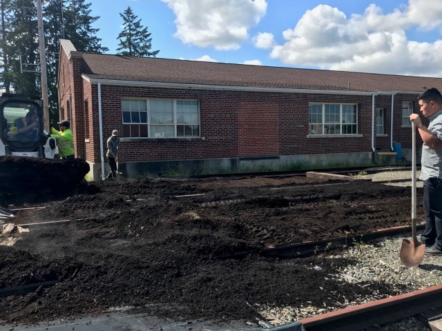 Integrated Training Area Management staff move compost into old railway lines to create new seed beds on Joint Base Lewis-McChord.