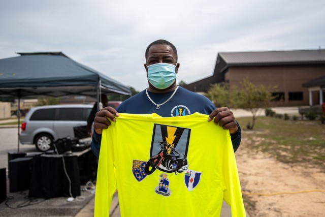 Mr. Dwight Blue holds up the brigade shirt he was presented with during the Lightening Rodeo he organized as part of the Motorcycle Mentorship Program, Oct. 9.
